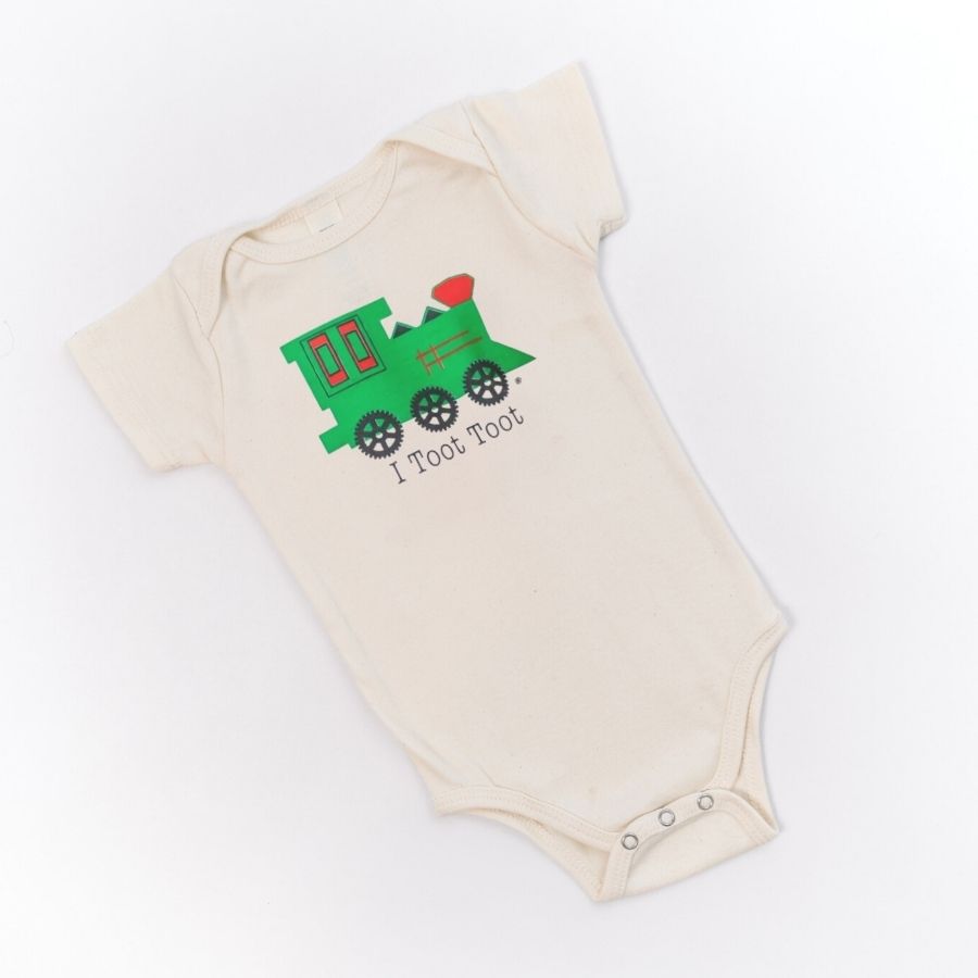 Beige baby onesie with green train design and 'I Toot Toot' text on a white background