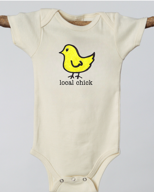 Off white baby onesie with a yellow chick graphic and 'local chick' text
