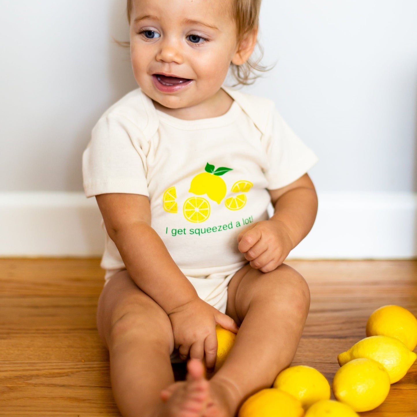 Simply Chickie I Get Squeezed A Lot Short Sleeve Baby Romper