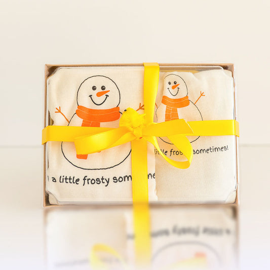 Packaged soap with snowman design and yellow ribbon on a light background