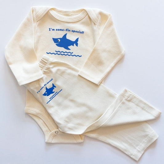 Baby outfit with long-sleeve shirt and pants featuring a shark design and text on a white background.