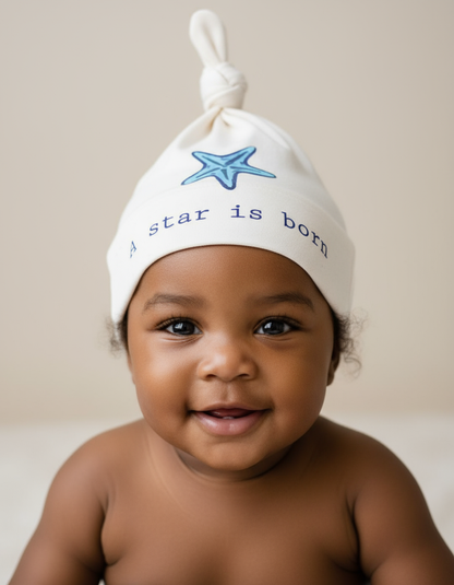 Black baby wearing A Star Is Born hat