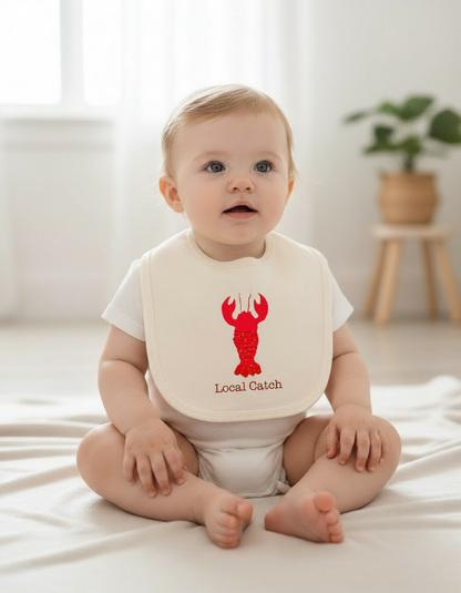 White baby girl wearing Lobster bib with white romper