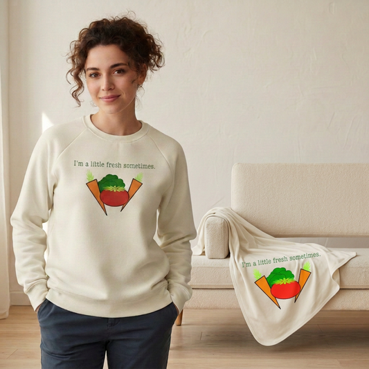 Woman in the veggie sweatshirt with the baby blanket draped over the couch